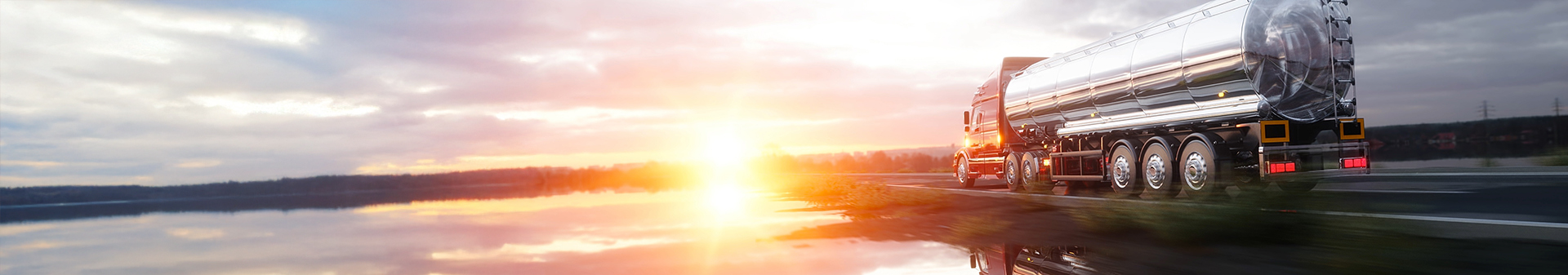 Truck fitted with reliable tyres hauling a tanker trailer on a highway.